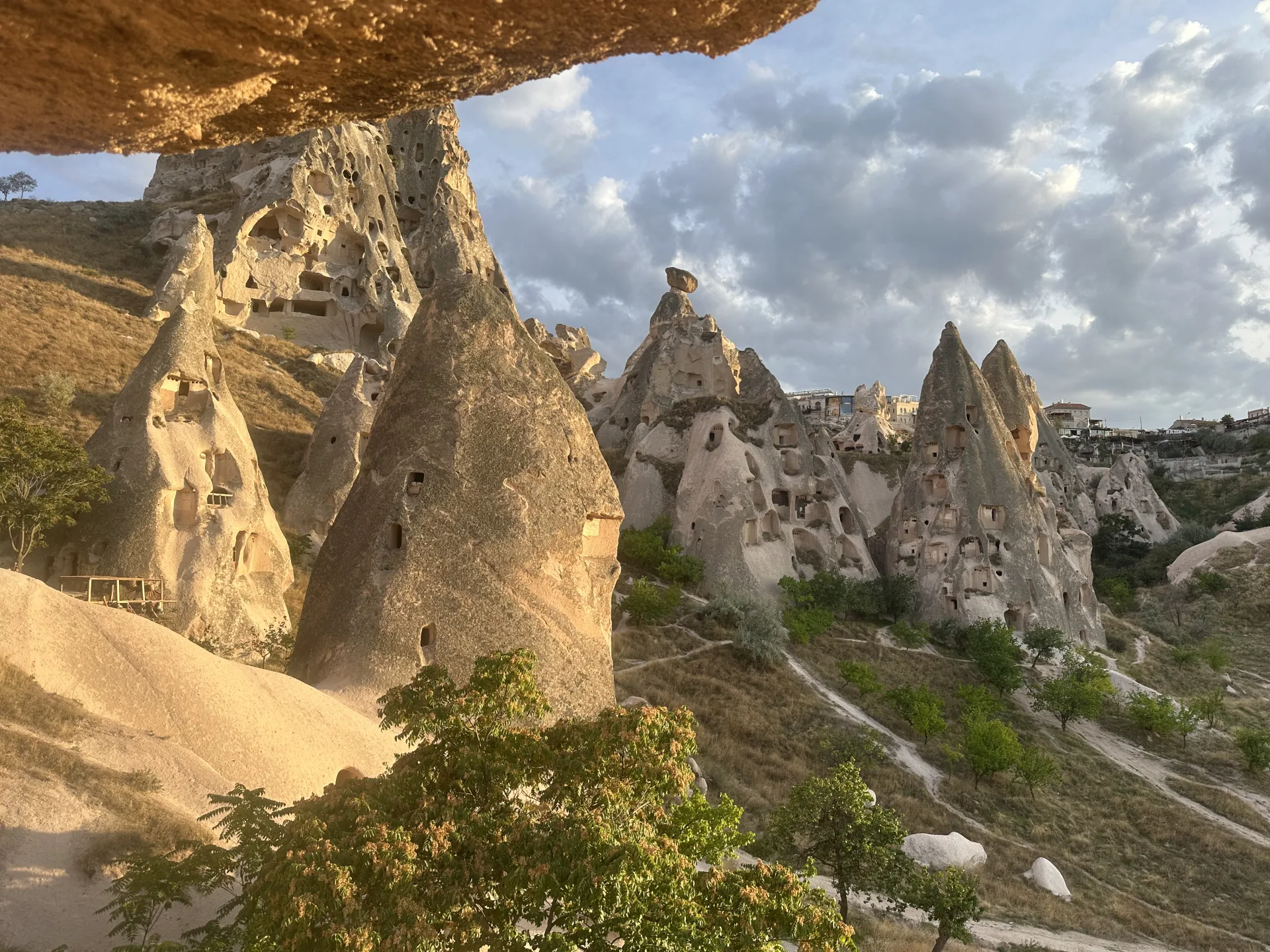 Cappadocia’s rock dwellings framed by an overhanging cliff
