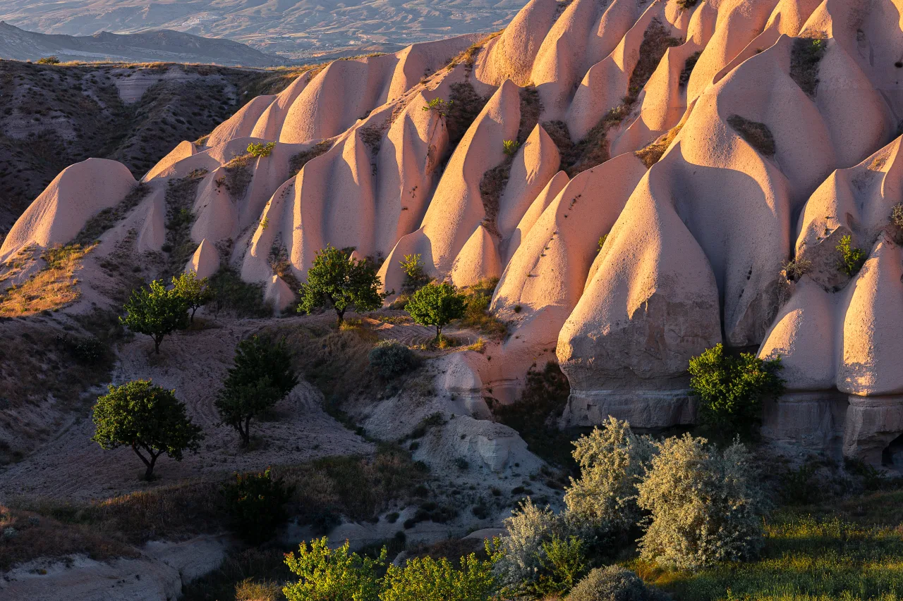 Rounded rock formations and a valley path in Cappadocia