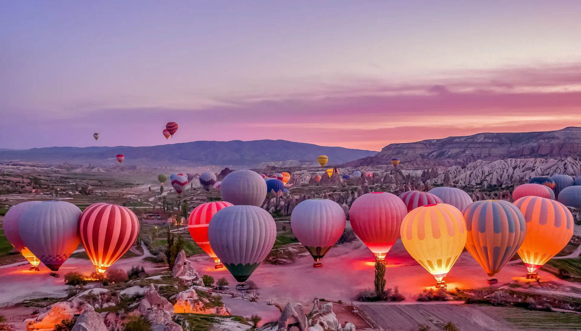 Balloons being prepared among Cappadocia’s valleys before sunrise