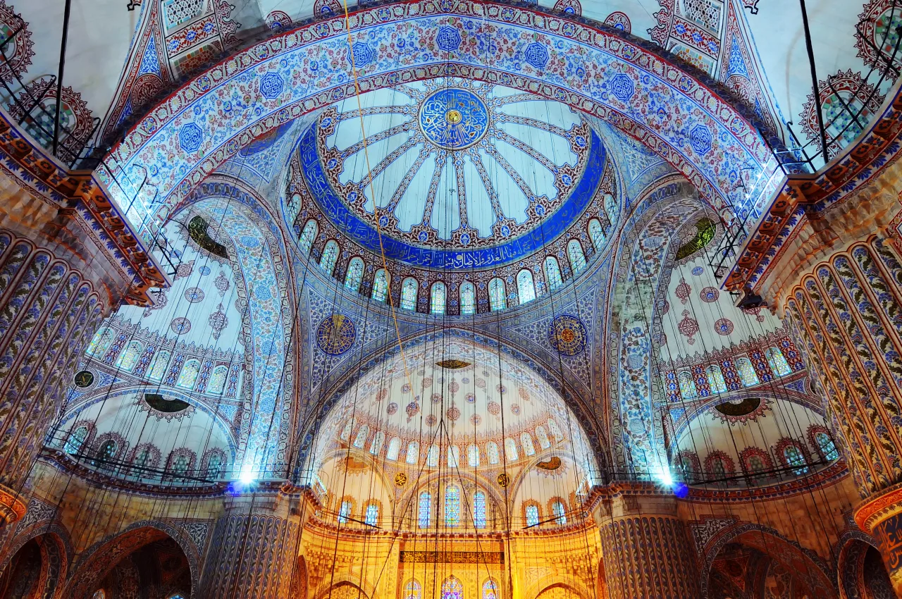 Painted domes and decorative arches inside the Blue Mosque